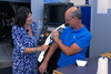  – Carolin Lang, Senior Marketing&nbsp;Manager Media & Communications, compares the arm of a humanoid robot with the arm of Michael&nbsp;Dreer.