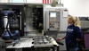  – A WPP machinist oversees the DMG MORI NLX 2500/700, a high-rigidity turning center, while a Doosan cobot manages the automated handling of workpieces enabling "lights-out" manufacturing.