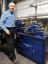  – Managing Director Duncan Dunbar with the machine that helped start the business - a Boxford lathe